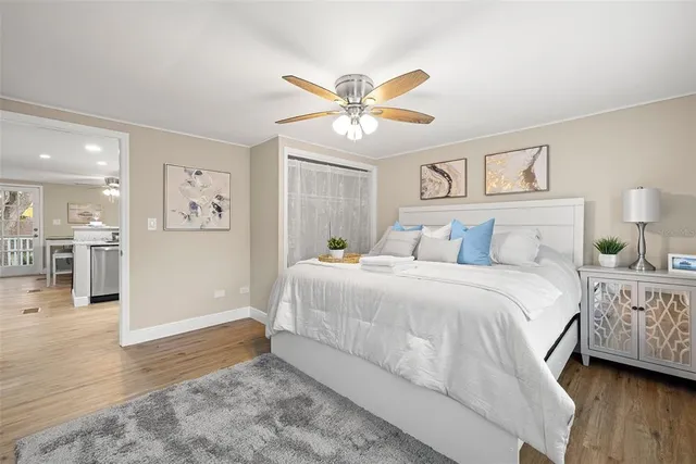 a bedroom with a bed and a chandelier