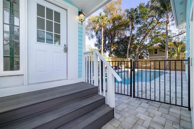 a view of backyard with deck and wooden floor