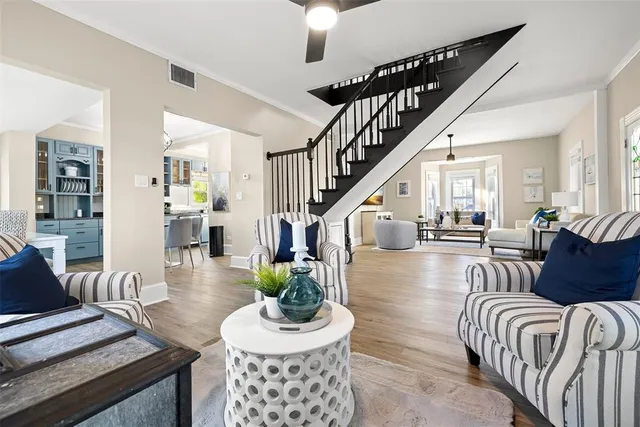 a living room with furniture and wooden floor