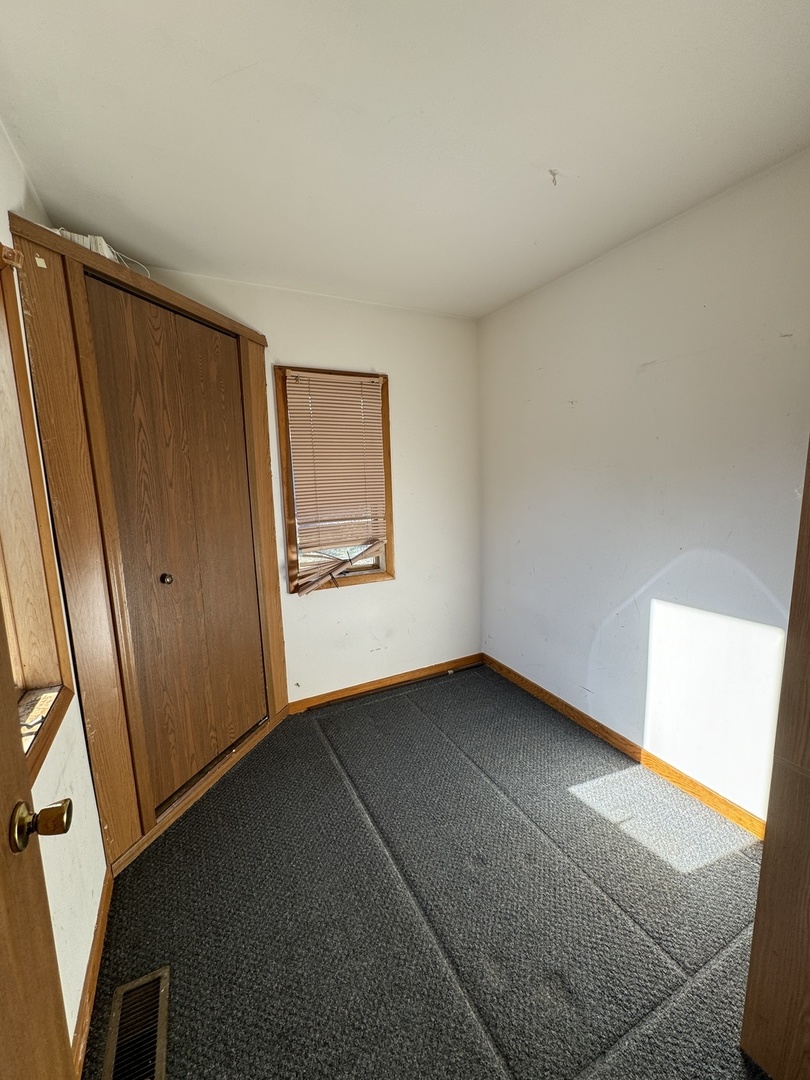215 Ash Road Kingston, IL 60145 - Photo 6 of 9 a view of an empty room and a window