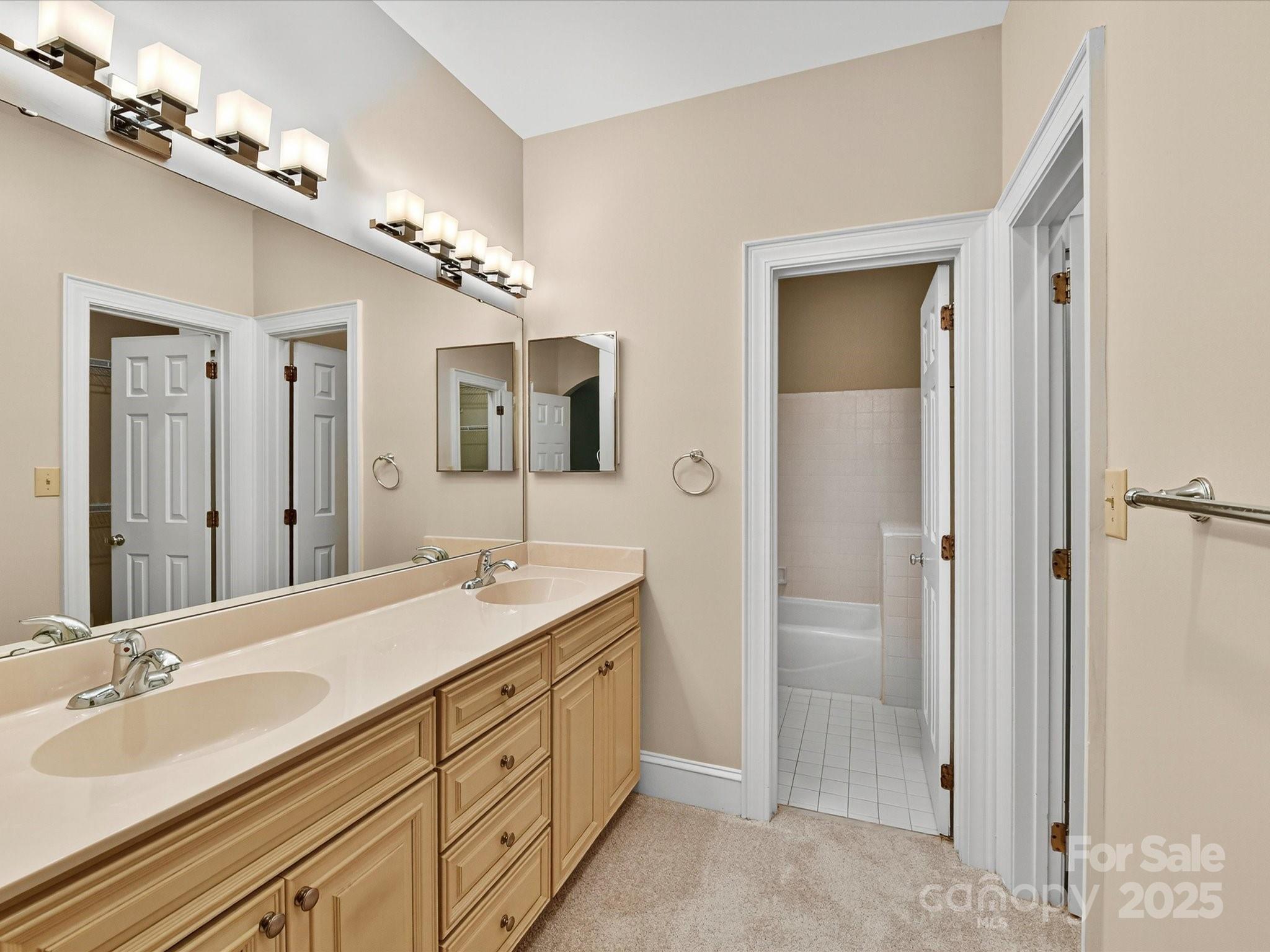325 Queens Road, Unit 2 Charlotte, NC 28204 - Photo 14 of 25 a spacious bathroom with a double vanity sink mirror and shower