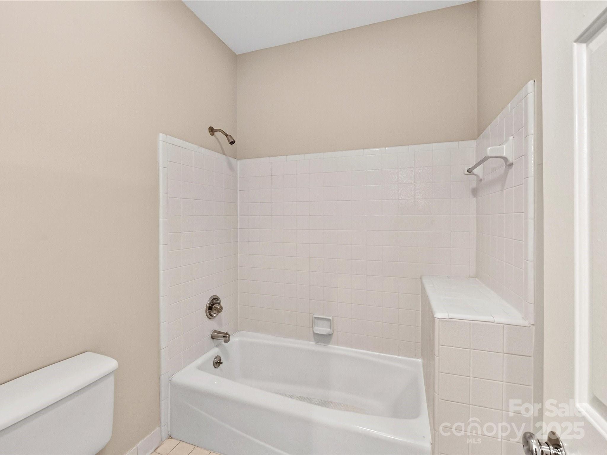 325 Queens Road, Unit 2 Charlotte, NC 28204 - Photo 15 of 25 a bathroom with a bathtub and a toilet