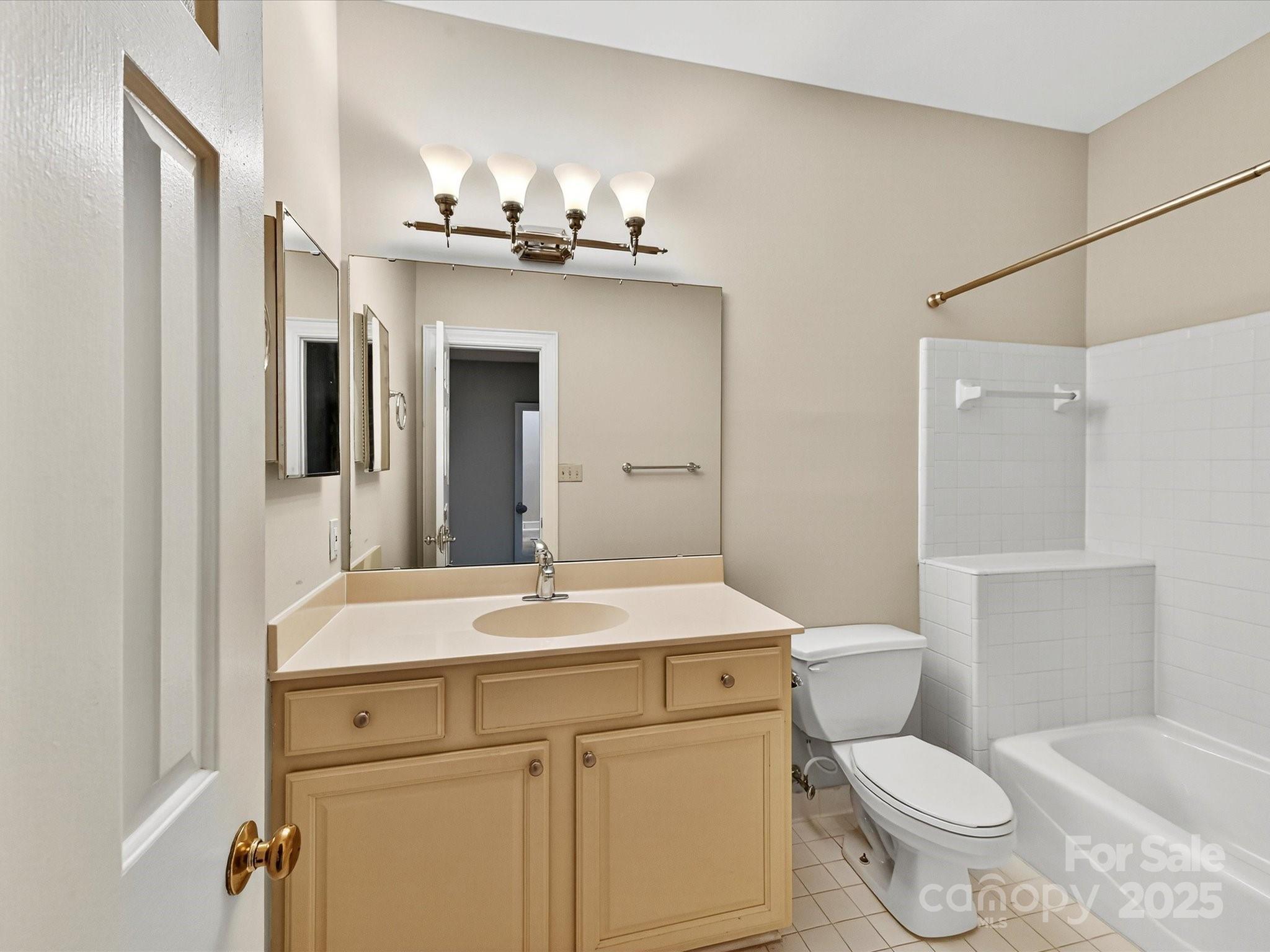 325 Queens Road, Unit 2 Charlotte, NC 28204 - Photo 21 of 25 a bathroom with a sink a toilet a mirror and shower