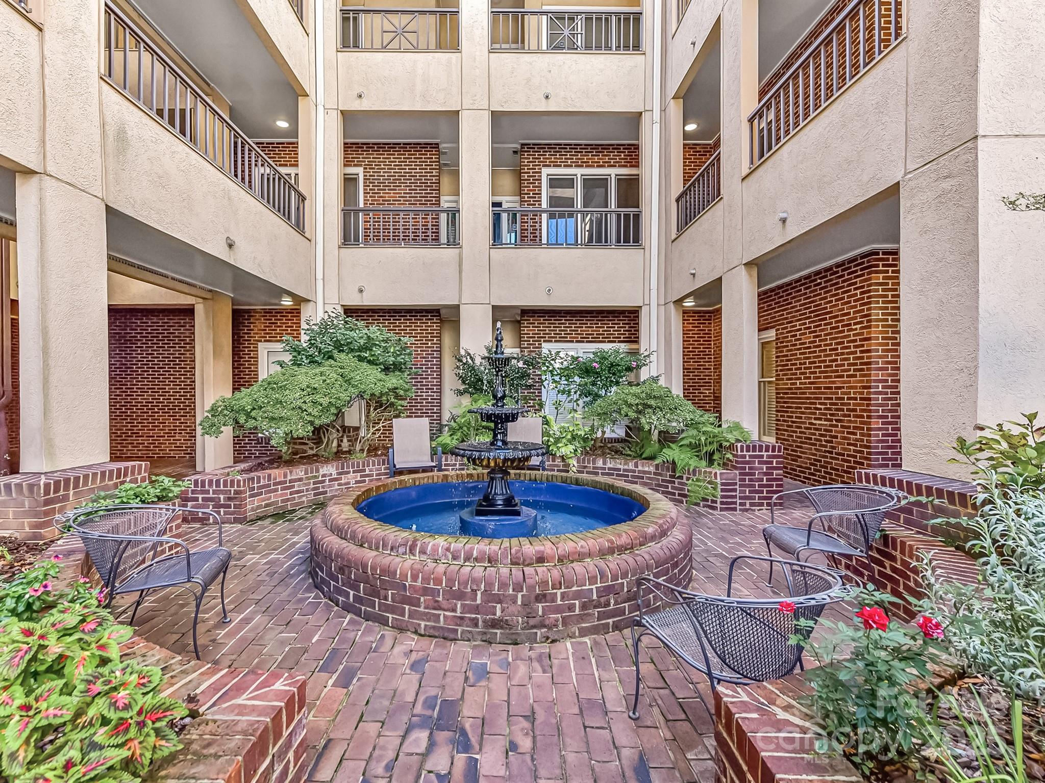 325 Queens Road, Unit 2 Charlotte, NC 28204 - Photo 24 of 25 a view of white house with plants and outdoor seating
