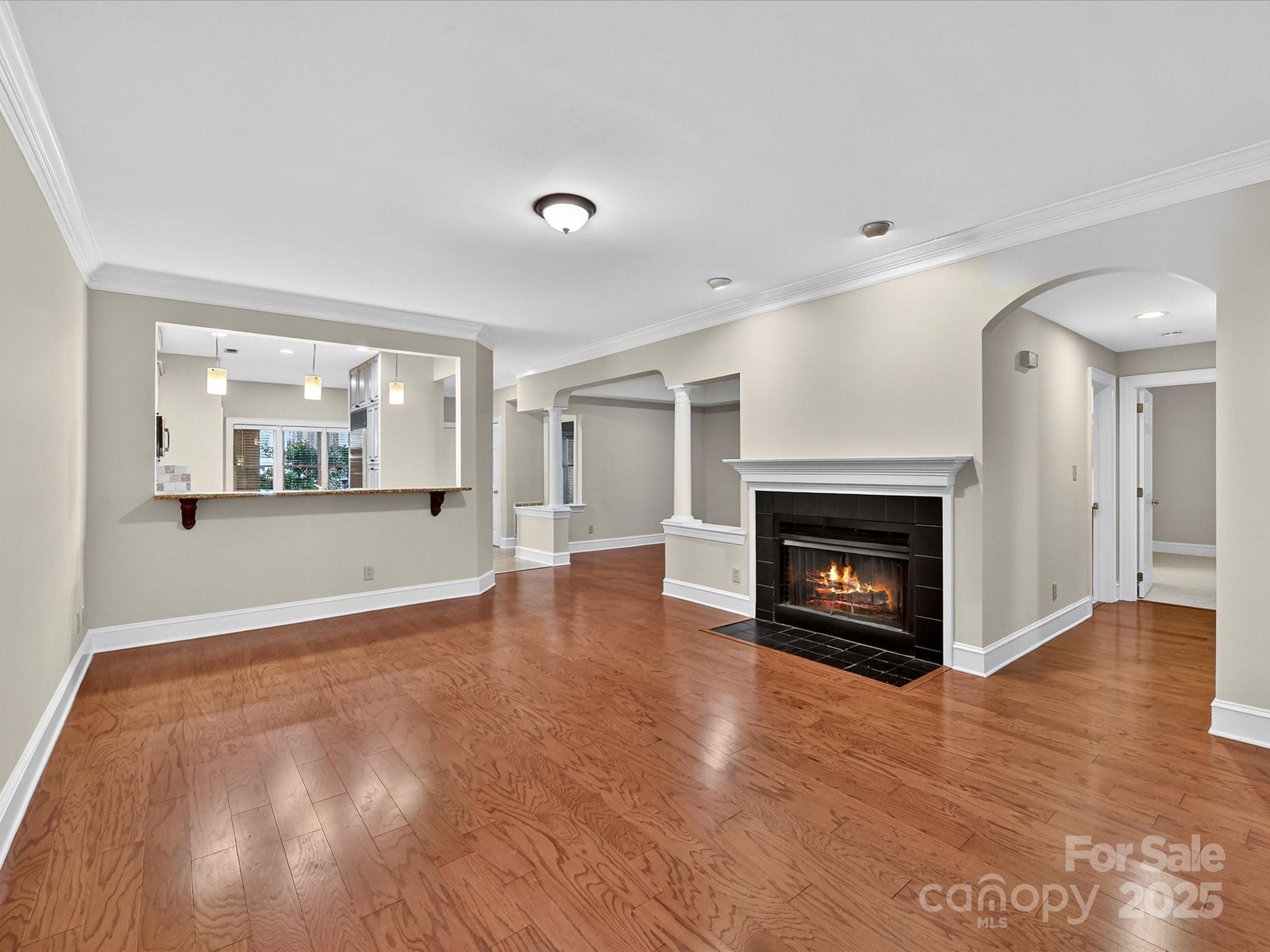 325 Queens Road, Unit 2 Charlotte, NC 28204 - Photo 7 of 25 a view of an empty room with a fireplace and a window