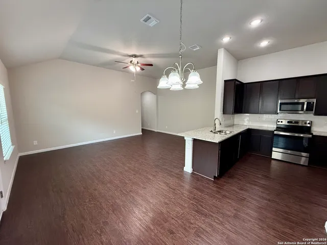 a view of kitchen with sink microwave and cabinets