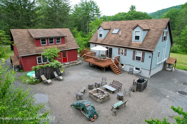 a aerial view of a house with swimming pool and garden