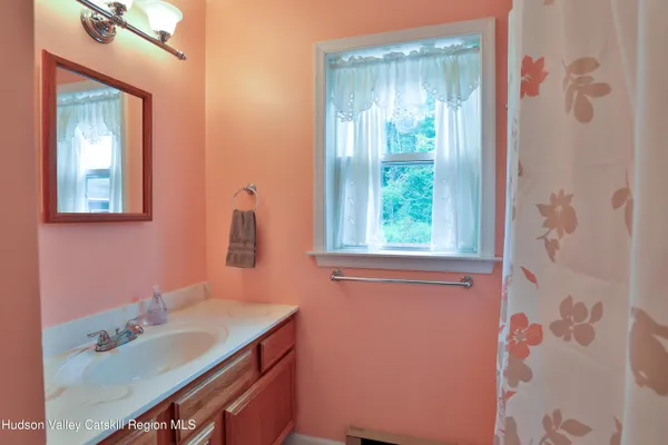 a bathroom with a sink vanity granite and a mirror