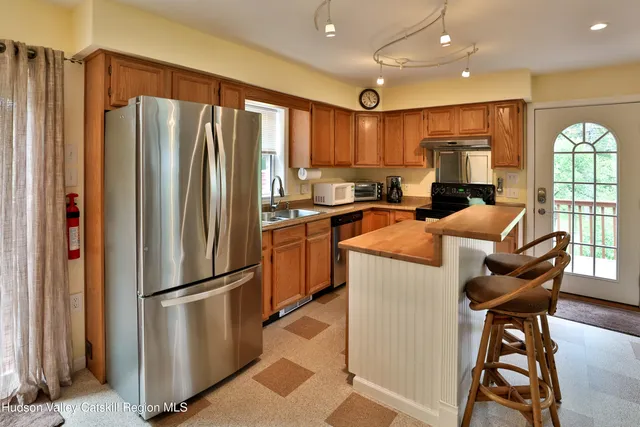 a kitchen with stainless steel appliances granite countertop a refrigerator stove microwave and sink