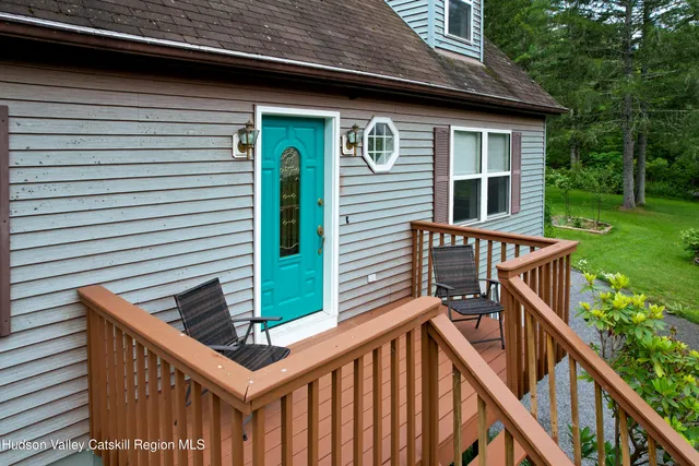 a view of a house with backyard and deck