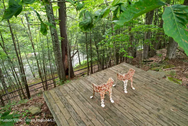an aerial view of a house with pool outdoor seating and trees