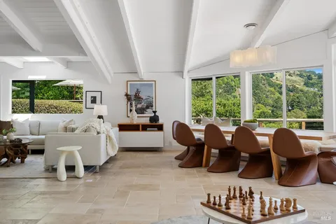 a kitchen with stainless steel appliances granite countertop a sink a stove and white cabinets