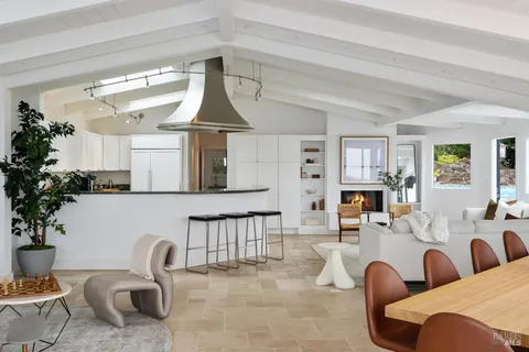 a bathroom with a sink mirror toilet and next to a window