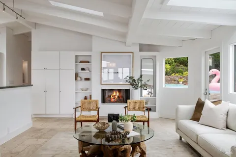 a bedroom with a bed a mirror and a window