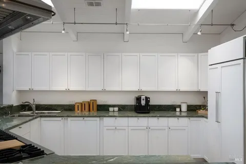 a bathroom with a shower sink vanity and mirror
