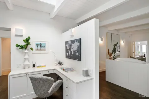 a view of a house with a yard and potted plants