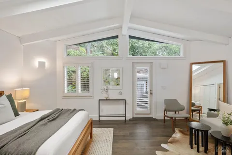 a view of a patio with couches table and chairs and potted plants