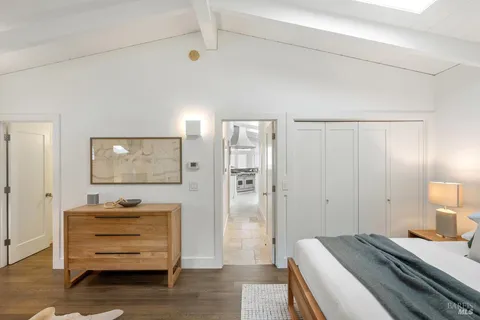 a view of a swimming pool with lawn chairs under an umbrella