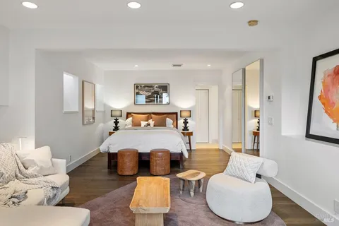 a bed sitting in a bedroom next to a window