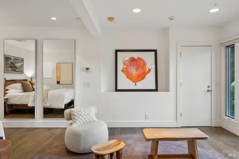a bedroom with furniture and a book shelf