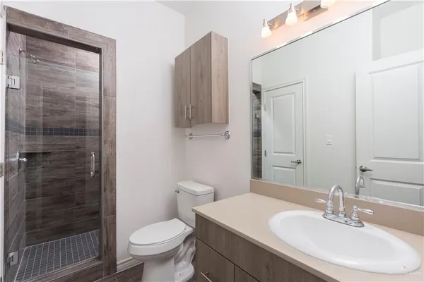 a bathroom with a sink toilet and shower