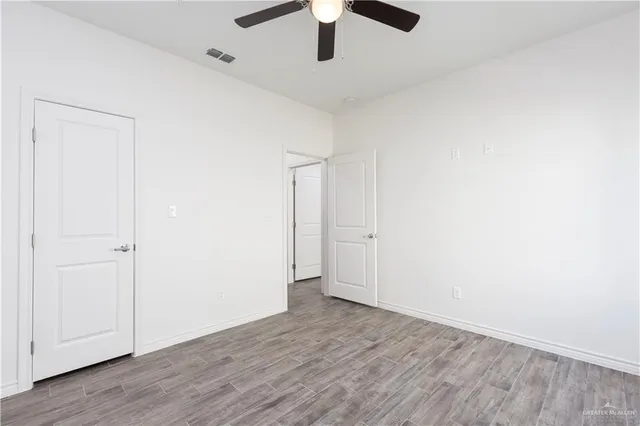 an empty room with wooden floor