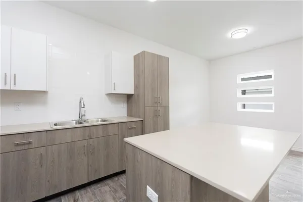 a kitchen with a sink dishwasher and cabinets