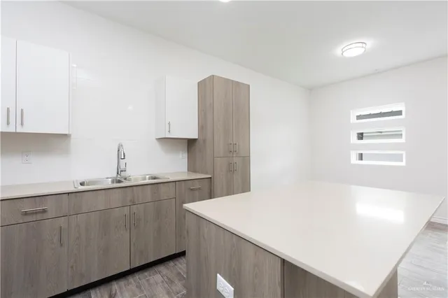 a kitchen with a sink dishwasher and cabinets