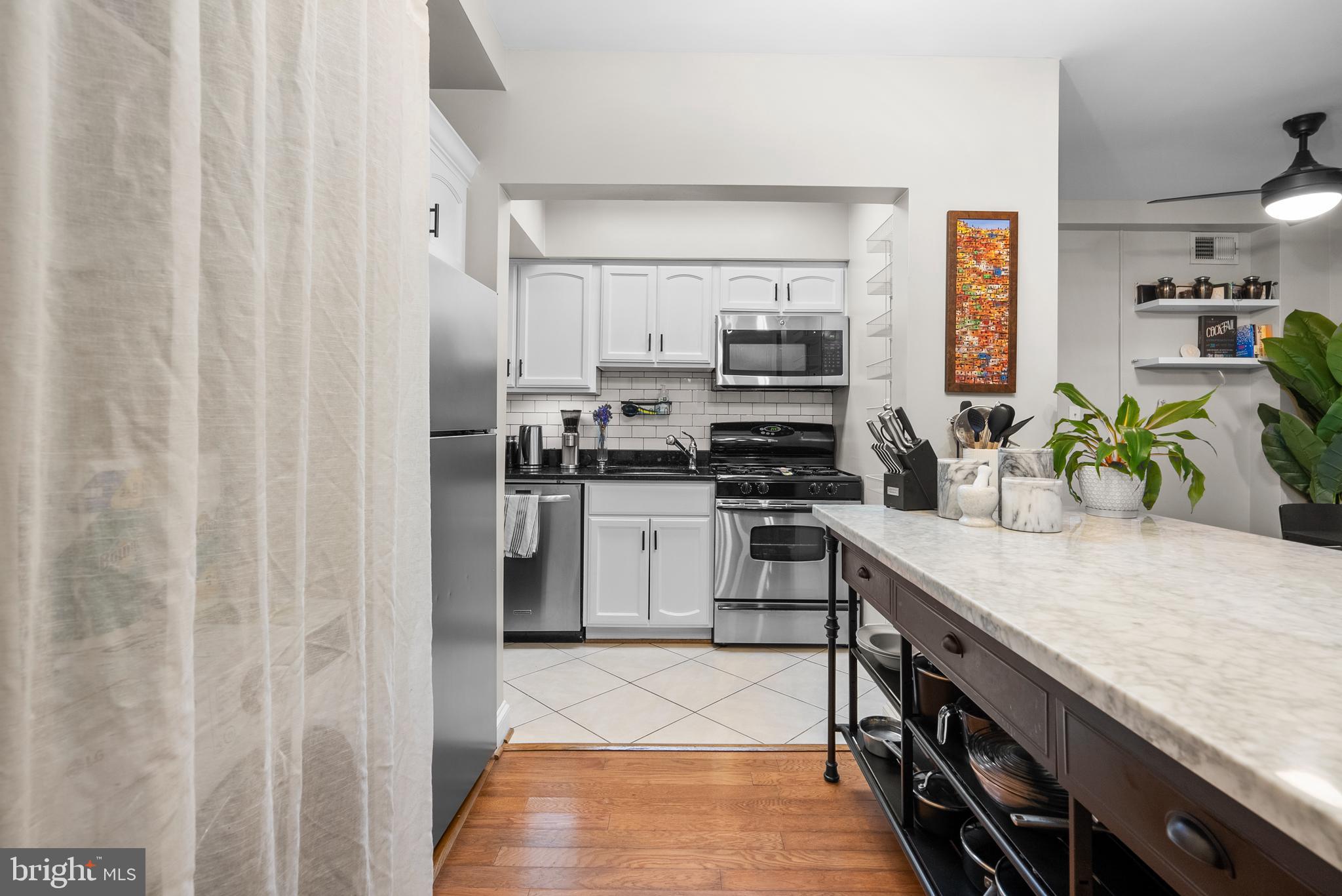 718 Park Road Northwest, Unit 1 Washington, DC 20010 - Photo 15 of 28 a kitchen with stainless steel appliances a stove and a refrigerator