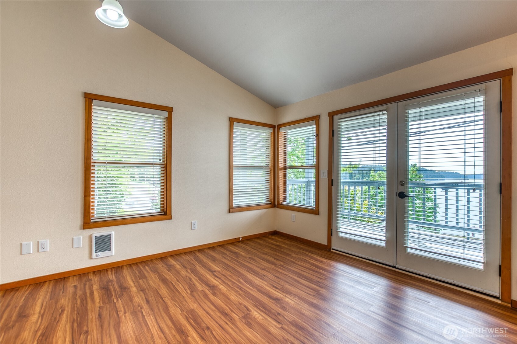 942 Deer Harbor Road Orcas Island, WA 98245 - Photo 17 of 40 a view of an empty room with wooden floor and a window