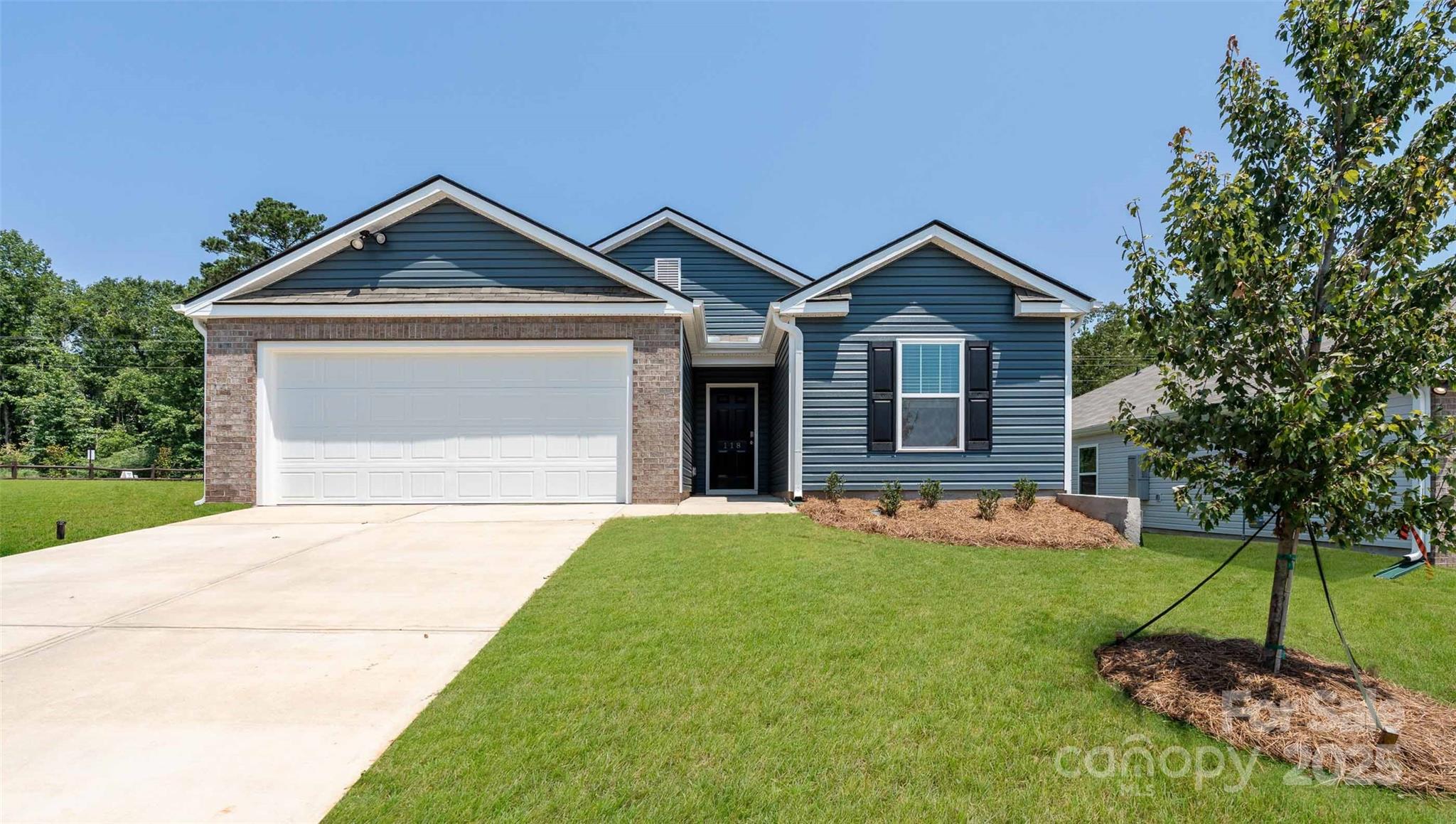 10 Callie River Clyde, NC 28721 - Photo 1 of 23 a front view of a house with a yard and garage