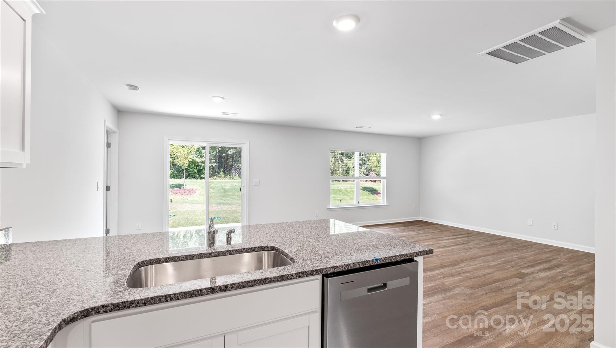 10 Callie River Clyde, NC 28721 - Photo 14 of 23 a kitchen with granite countertop a sink and a window