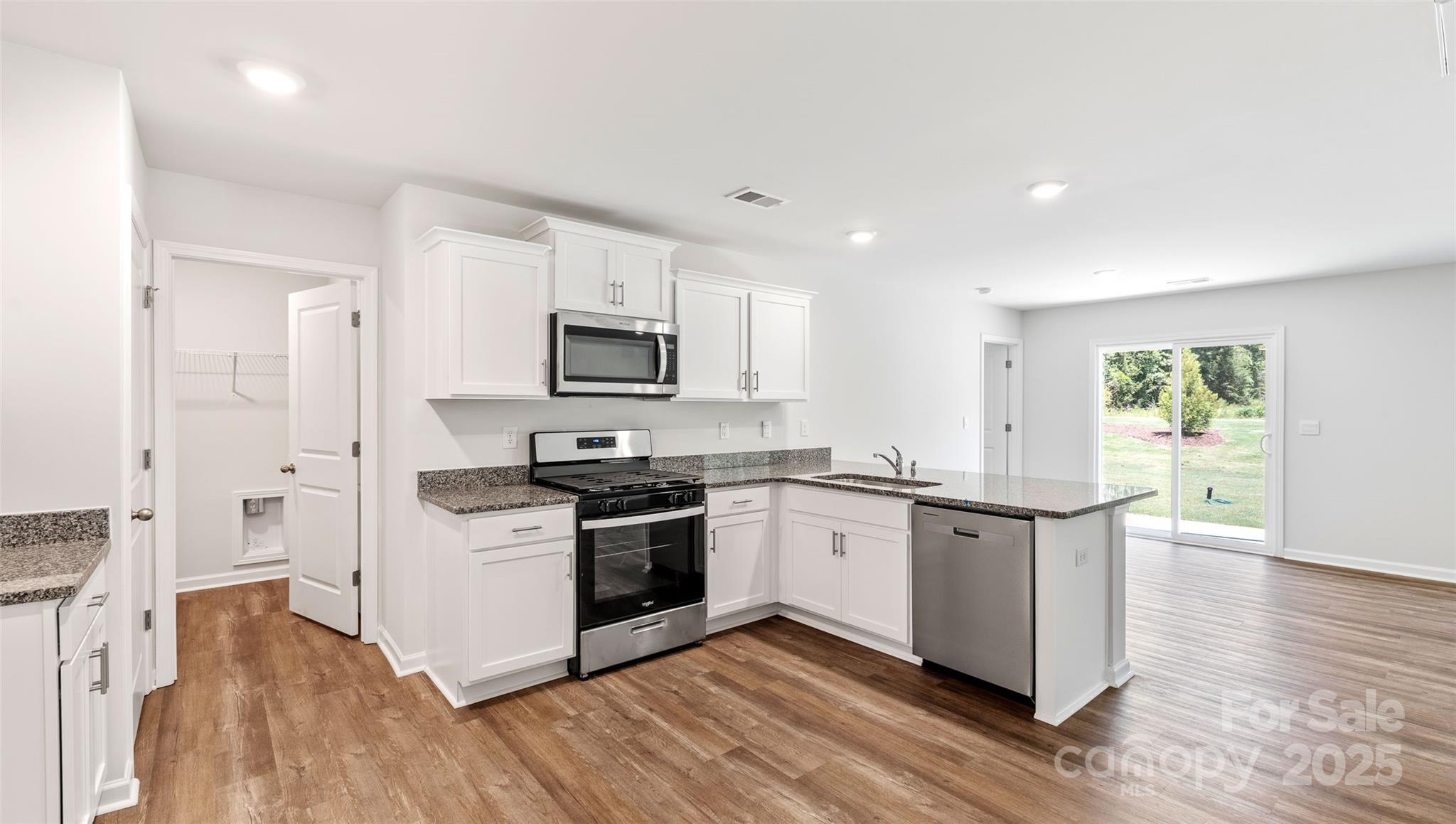 10 Callie River Clyde, NC 28721 - Photo 16 of 23 a kitchen with granite countertop a stove top oven and sink