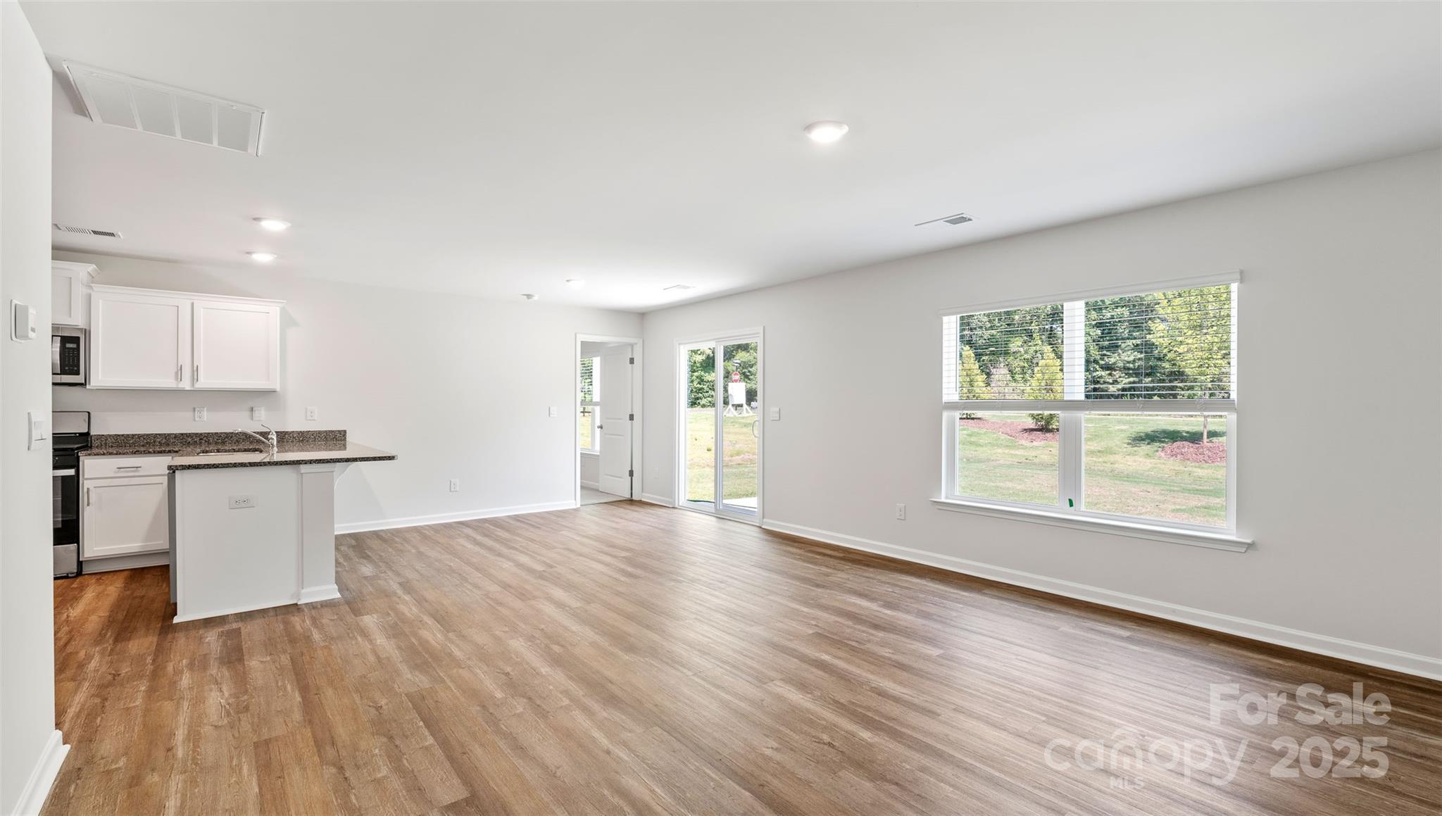 10 Callie River Clyde, NC 28721 - Photo 21 of 23 a view of a kitchen with wooden floor and a window