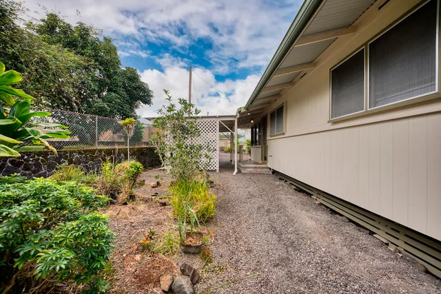 a backyard of a house with a table and chairs