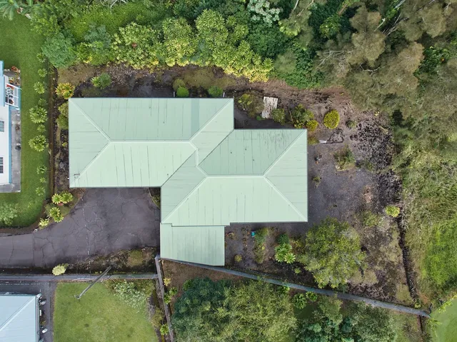 an aerial view of a house with a yard