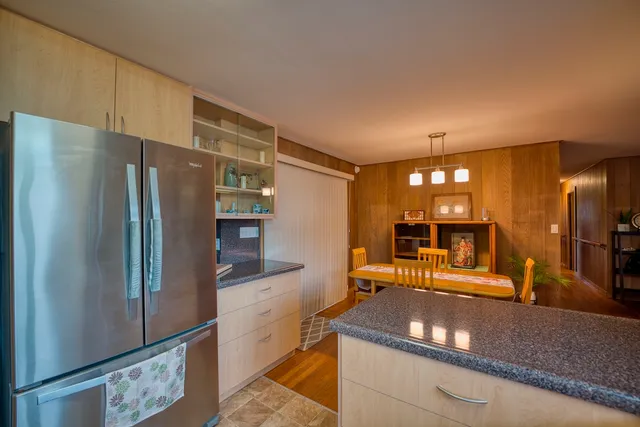 a kitchen with stainless steel appliances granite countertop a refrigerator and a sink