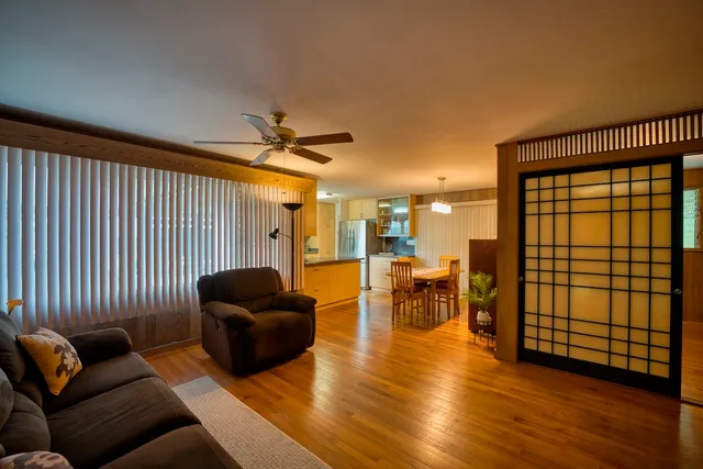a living room with furniture and wooden floor