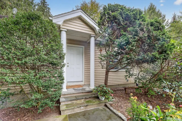 a view of house with backyard and garden