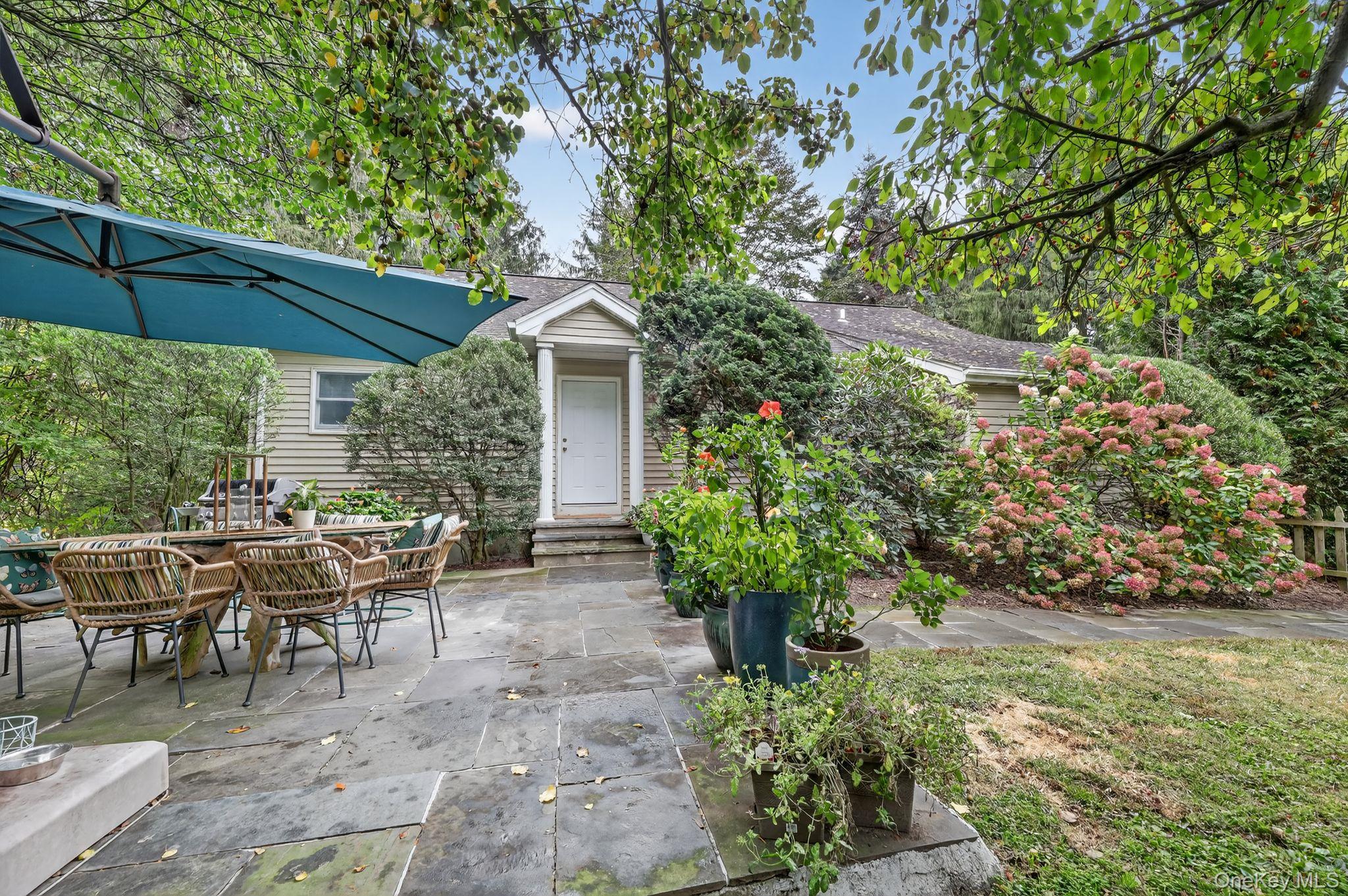 20 Old Mt Kisco Road Armonk, NY 10504 - Photo 20 of 50 a view of a patio with table and chairs under an umbrella
