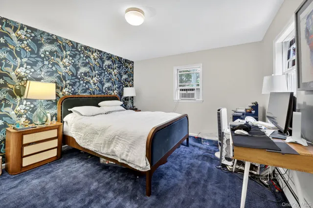 a bedroom with a bed and a desk