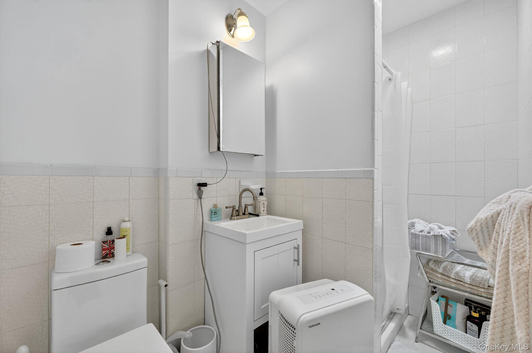 20 Old Mt Kisco Road Armonk, NY 10504 - Photo 44 of 50 a bathroom with a sink a toilet and a mirror