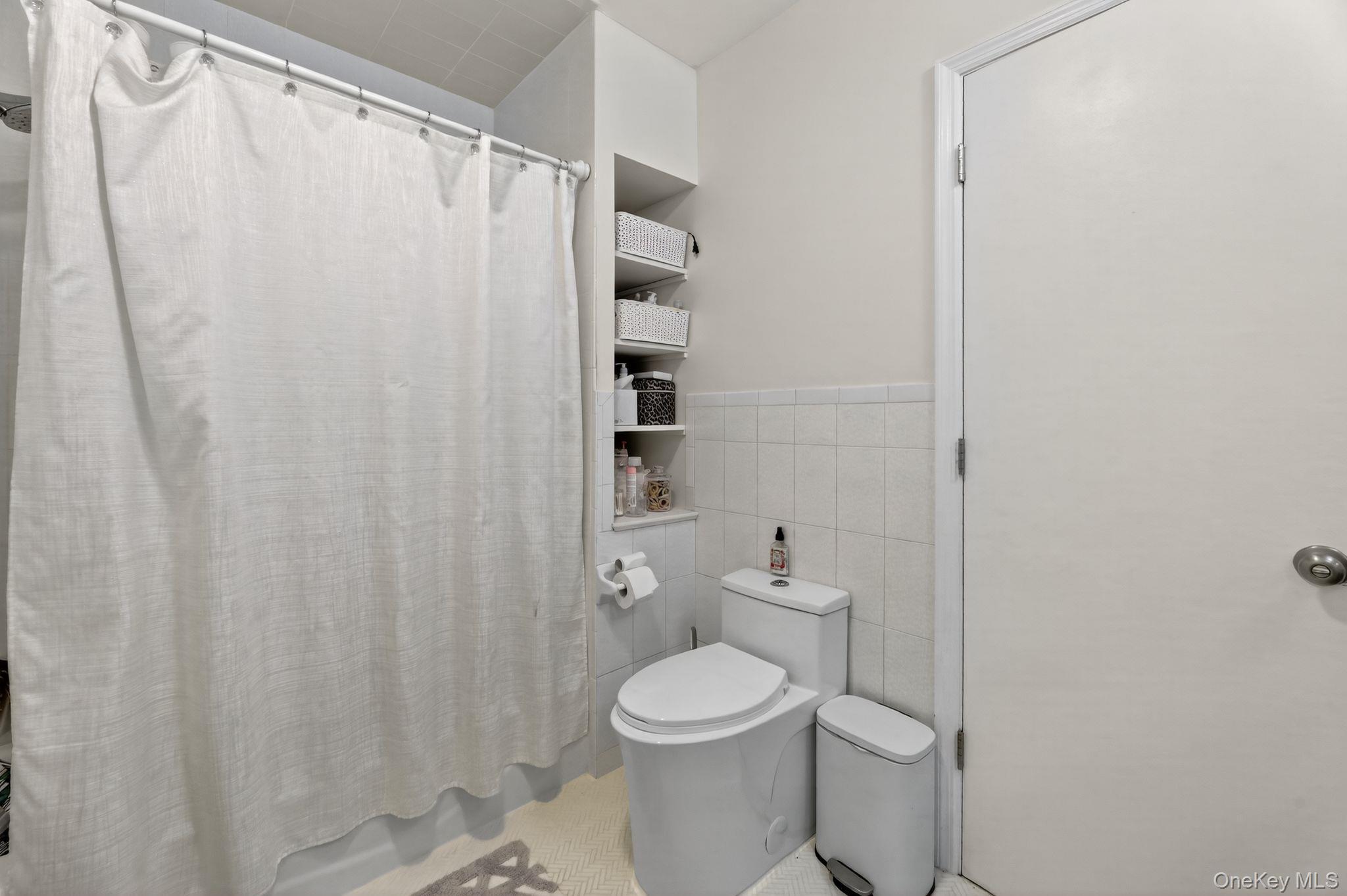 20 Old Mt Kisco Road Armonk, NY 10504 - Photo 45 of 50 a white toilet sitting next to a shower curtain