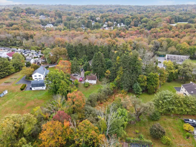an aerial view of a houses with a yard