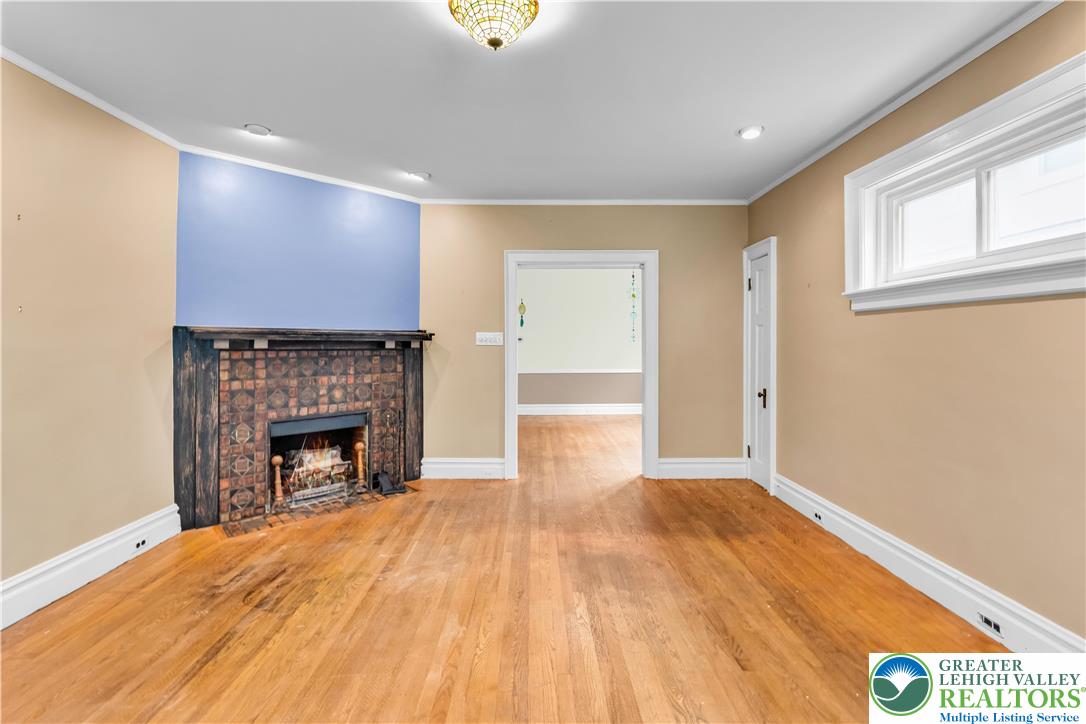 1722 Maple Street Bethlehem, PA 18017 - Photo 5 of 30 a view of empty room with wooden floor and fireplace