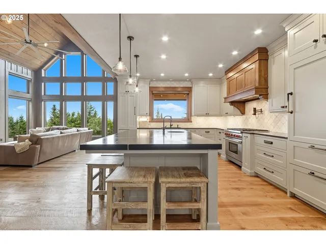 a kitchen with kitchen island granite countertop a sink window and cabinets