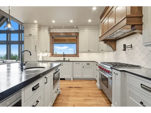 a living room with furniture fireplace and floor to ceiling windows