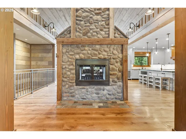 a dining room with chandelier wooden floor and windows