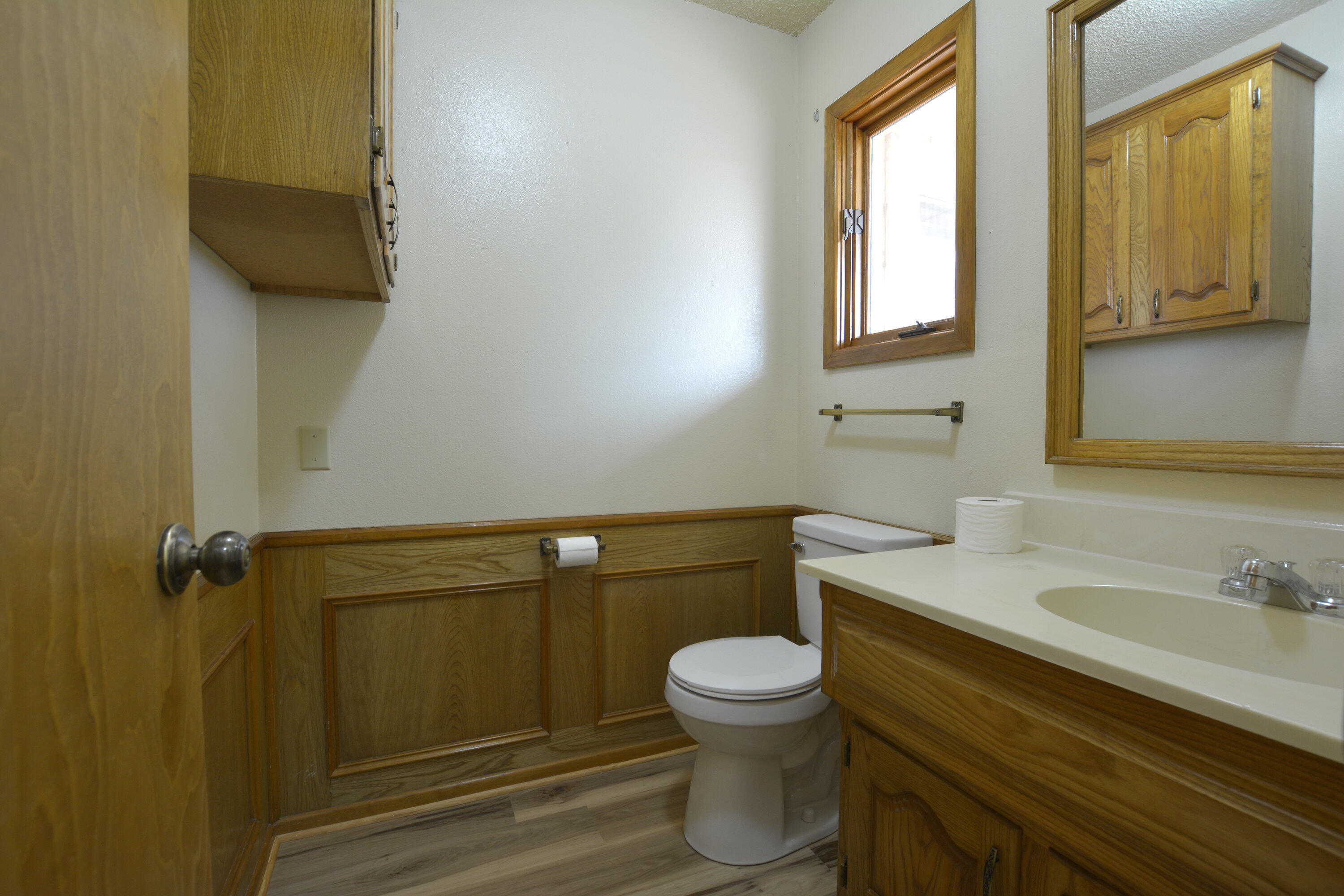5224 9th Street Lubbock, TX 79416 - Photo 11 of 26 a bathroom with a sink a toilet and mirror