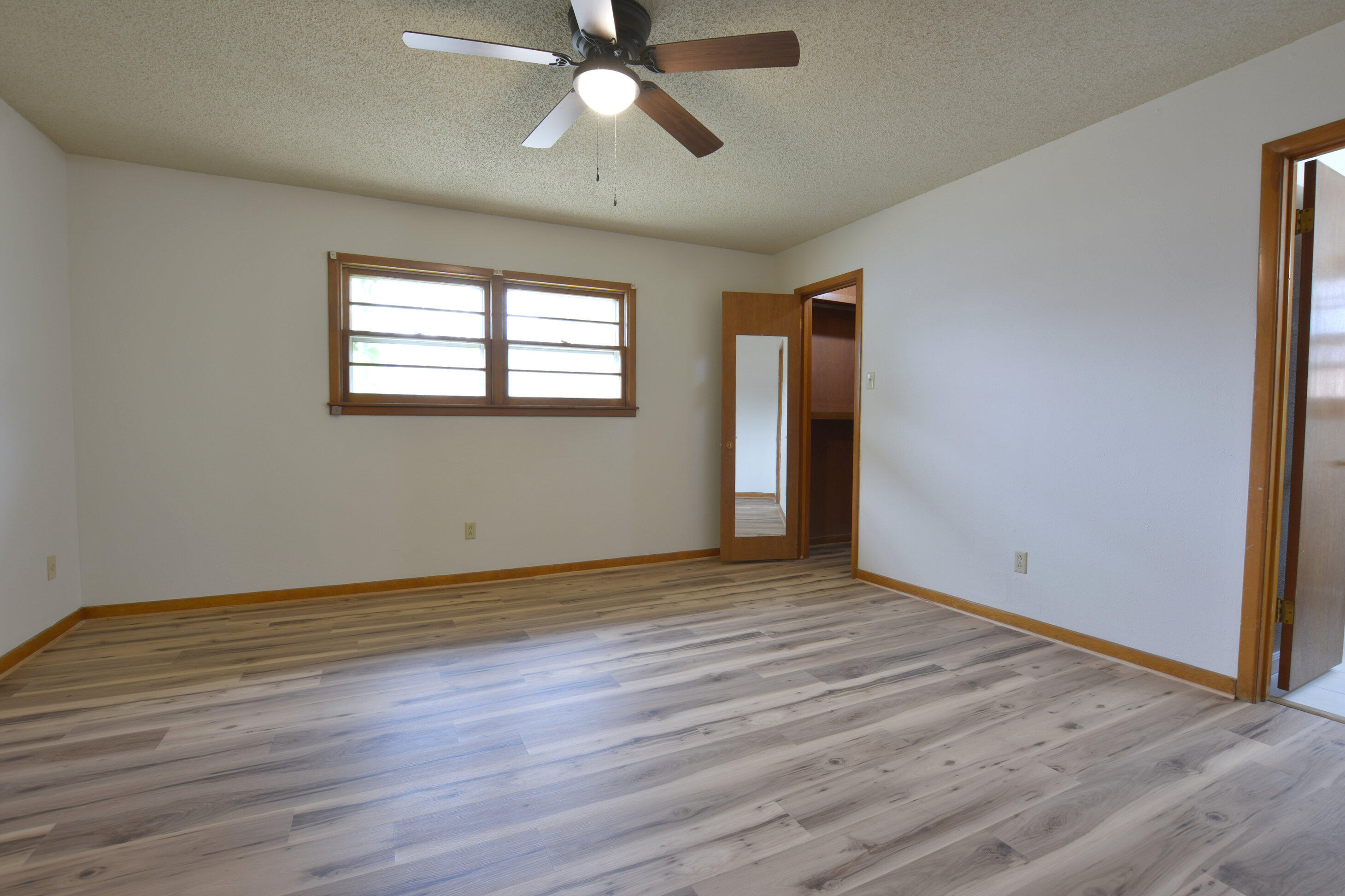 5224 9th Street Lubbock, TX 79416 - Photo 16 of 26 an empty room with wooden floor fan and windows